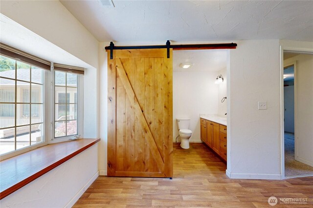 1557 Shelton Rd, Walla Walla, WA 99362 - bathroom featuring vanity, wood finished floors, baseboards, and toilet
