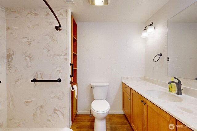 1557 Shelton Rd, Walla Walla, WA 99362 - bathroom featuring vanity, wood finished floors, toilet, and a shower