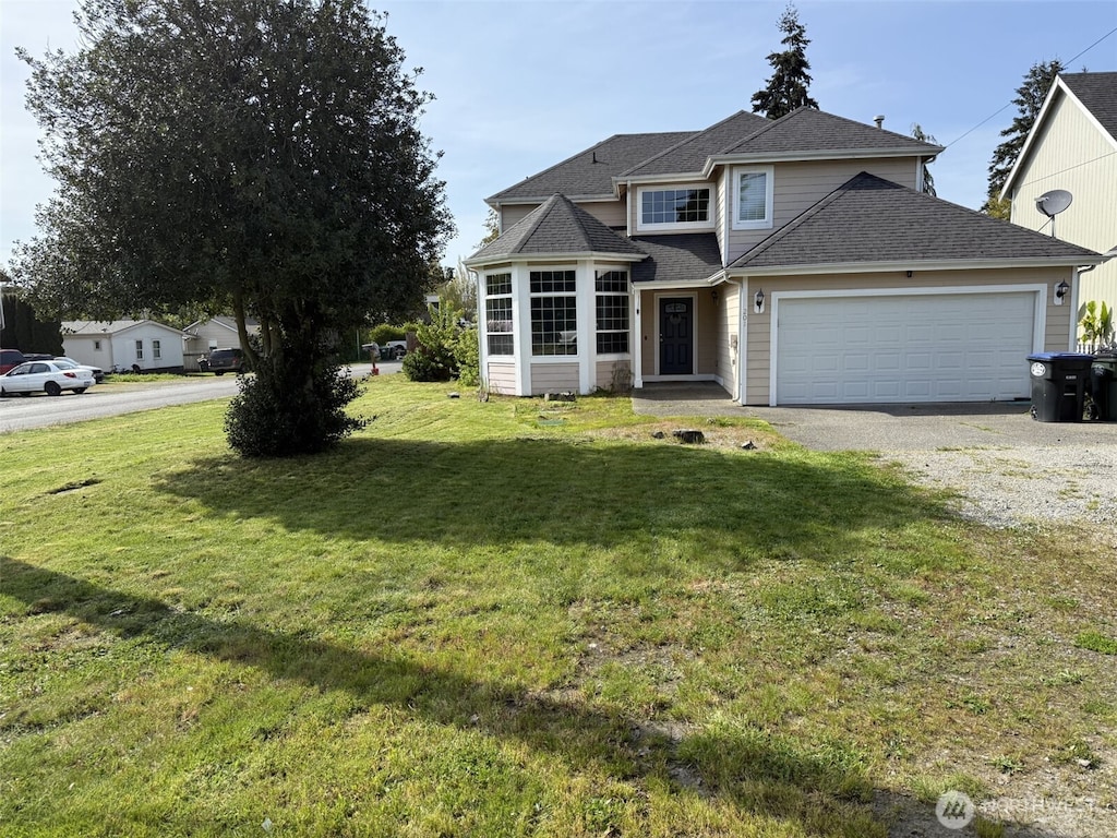 traditional-style home with a garage, a shingled roof, gravel driveway, and a front yard