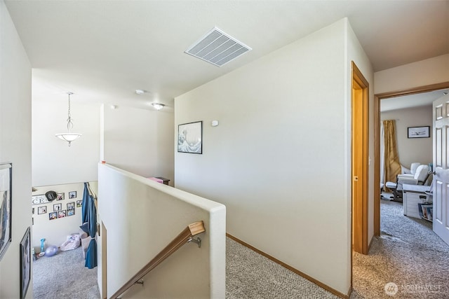 201 3rd St NE, Yelm, WA 98597 - hallway featuring carpet, visible vents, an upstairs landing, and baseboards
