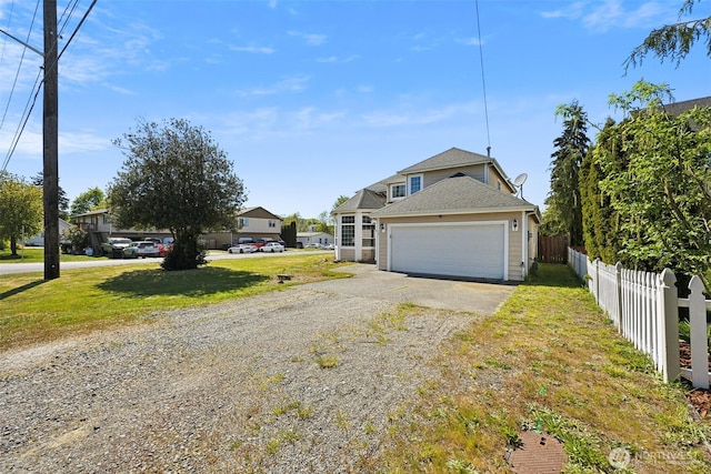 201 3rd St NE, Yelm, WA 98597 - traditional-style home with driveway, a front lawn, fence, and an attached garage