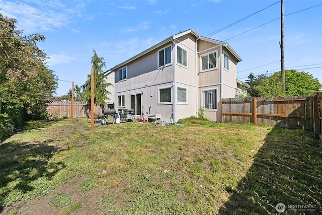 201 3rd St NE, Yelm, WA 98597 - back of house with a lawn and a fenced backyard