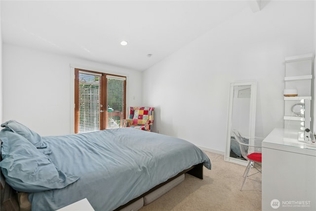carpeted bedroom featuring french doors and vaulted ceiling