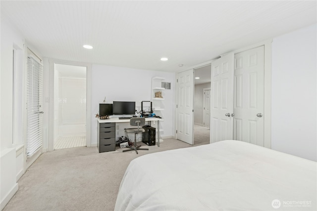 bedroom with recessed lighting, baseboards, light carpet, and ensuite bathroom