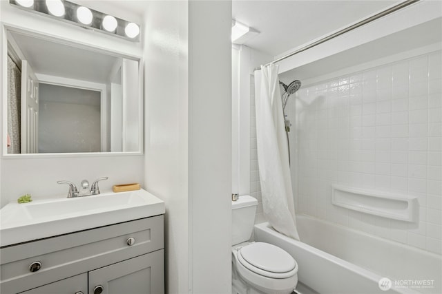 bathroom featuring vanity, shower / bath combo with shower curtain, and toilet
