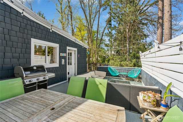 deck featuring grilling area, fence, and an outdoor living space