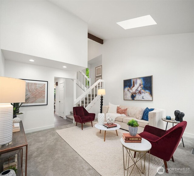 carpeted living area with stairs, recessed lighting, baseboards, and lofted ceiling with skylight
