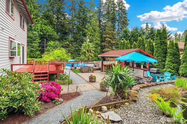 view of yard featuring a deck and a patio area