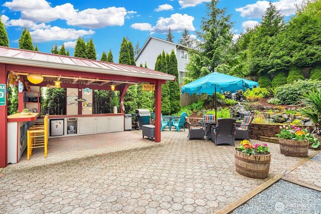 view of patio with a gazebo and outdoor dining area