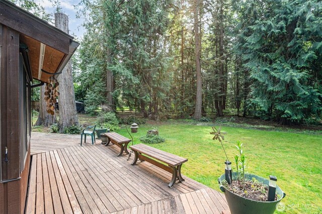 wooden terrace with a lawn