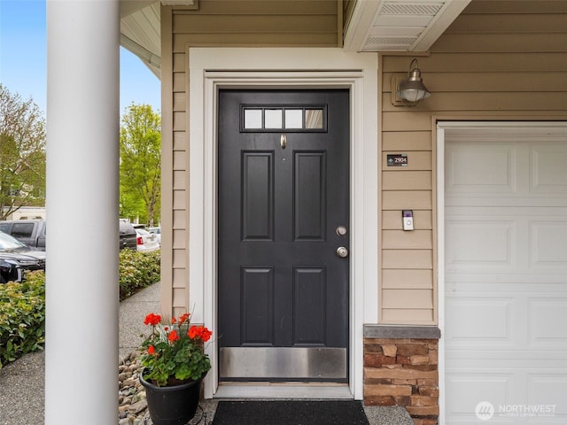 view of exterior entry with a garage