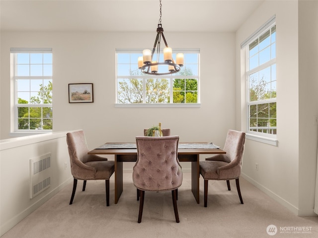 dining room with visible vents, baseboards, a chandelier, and carpet
