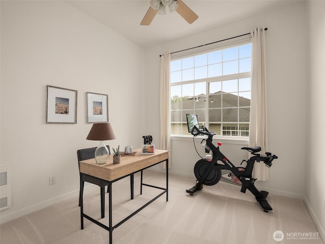 home office featuring baseboards, a ceiling fan, and light colored carpet