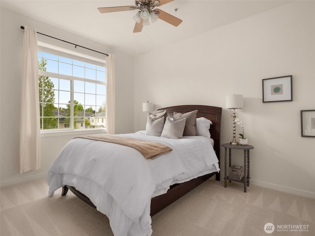 carpeted bedroom with baseboards and ceiling fan
