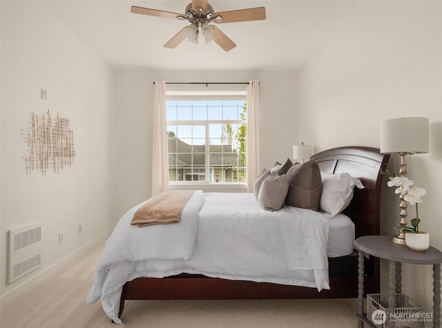 carpeted bedroom with baseboards, heating unit, and ceiling fan