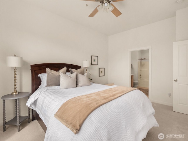 bedroom featuring connected bathroom, baseboards, light carpet, and ceiling fan