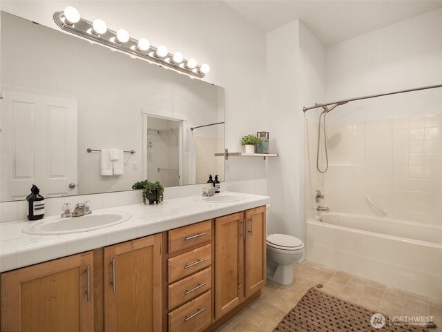 full bath featuring a sink, toilet, double vanity, and shower / tub combo with curtain