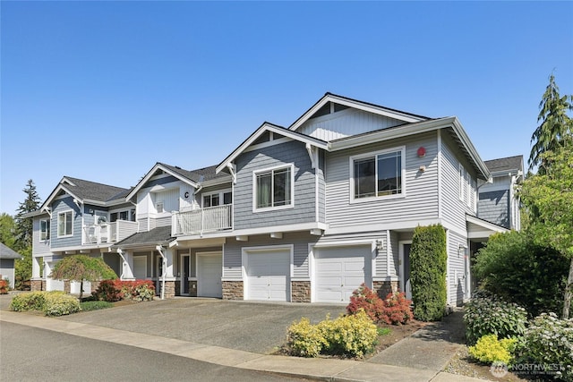 15720 Manor Way Unit C5, Lynnwood, WA 98087 - view of front facade featuring driveway, an attached garage, and stone siding