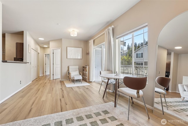 15720 Manor Way Unit C5, Lynnwood, WA 98087 - dining area with light wood-style flooring, baseboards, and arched walkways