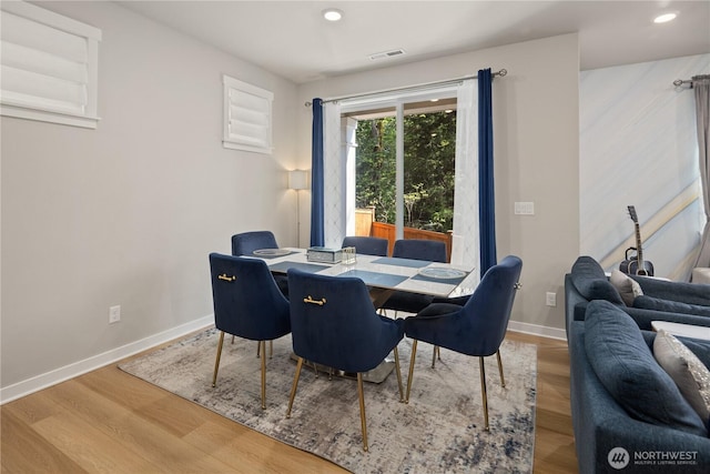 dining room featuring recessed lighting, baseboards, visible vents, and wood finished floors