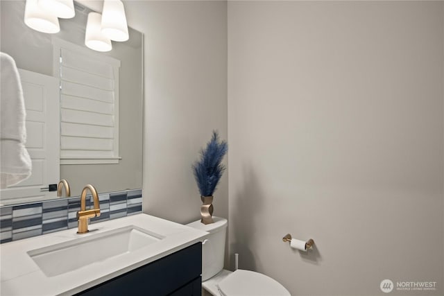 half bath featuring toilet and vanity