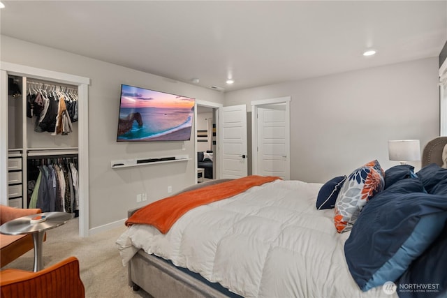 carpeted bedroom with recessed lighting, baseboards, a spacious closet, and a closet