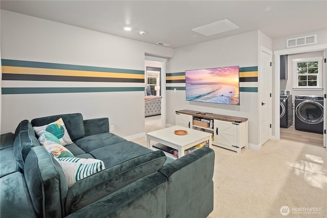 living area featuring independent washer and dryer, light carpet, recessed lighting, baseboards, and visible vents