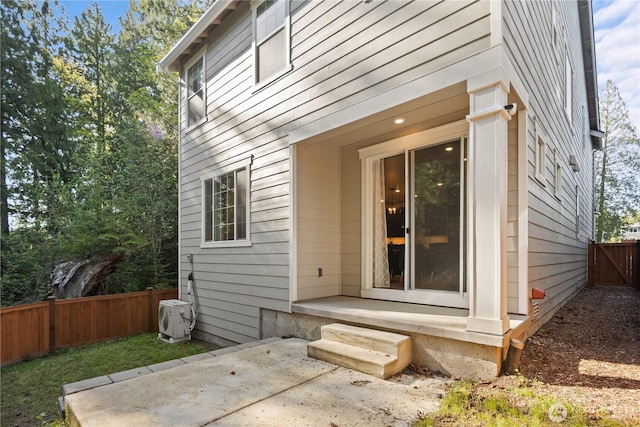 exterior space featuring fence, ac unit, and a patio area