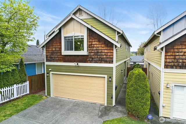 view of front of house with a garage and fence