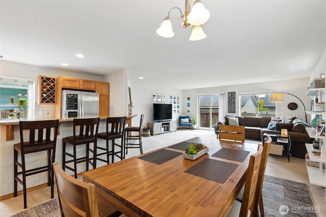 dining room with recessed lighting, a chandelier, and indoor bar