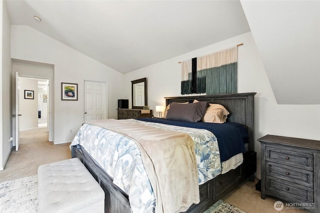 bedroom with light colored carpet and lofted ceiling