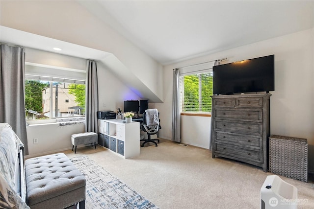 sitting room featuring baseboards, lofted ceiling, and light carpet