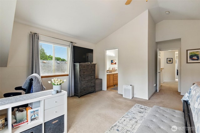 bedroom with high vaulted ceiling, ceiling fan, light carpet, and ensuite bath