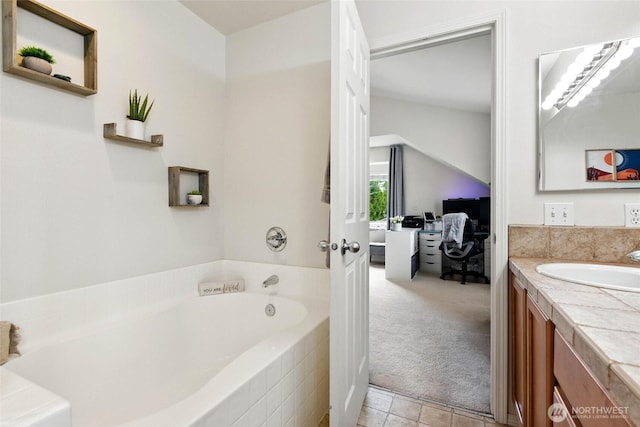 ensuite bathroom featuring vanity, a garden tub, ensuite bath, and tile patterned floors