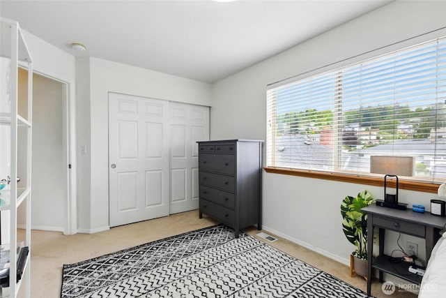 interior space featuring baseboards, light carpet, and visible vents