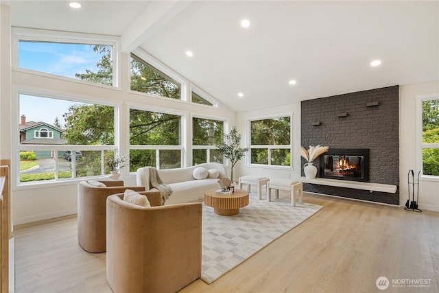 living area with a fireplace, high vaulted ceiling, beamed ceiling, light wood finished floors, and recessed lighting