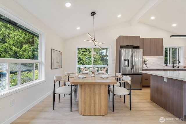 dining space with recessed lighting, baseboards, vaulted ceiling with beams, and light wood-style flooring