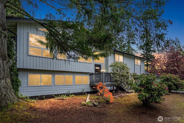 property exterior at dusk with a wooden deck