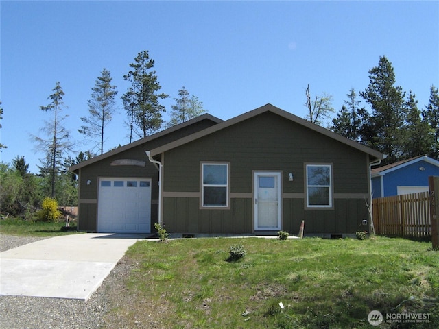 27510 X Ln, Ocean Park, WA 98640 - ranch-style house with fence, a front lawn, a garage, board and batten siding, and concrete driveway