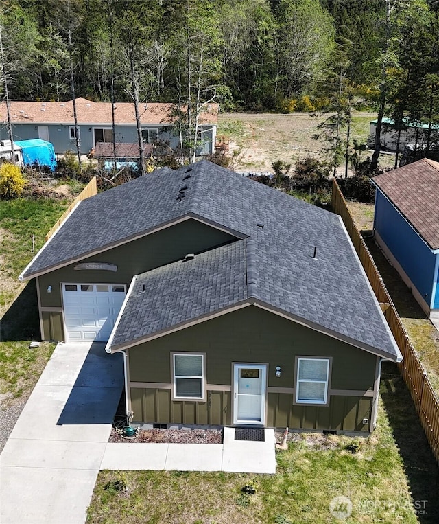 27510 X Ln, Ocean Park, WA 98640 - exterior space with a garage, fence, roof with shingles, board and batten siding, and concrete driveway