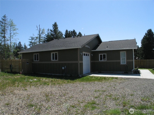 27510 X Ln, Ocean Park, WA 98640 - view of front of property featuring an attached garage, roof with shingles, fence, and a patio
