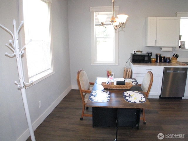 27510 X Ln, Ocean Park, WA 98640 - dining area featuring an inviting chandelier, baseboards, and dark wood-type flooring