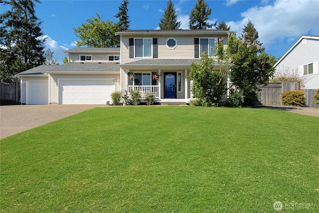 traditional-style home featuring a garage, a front lawn, fence, covered porch, and concrete driveway