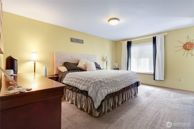 bedroom with baseboards and light carpet