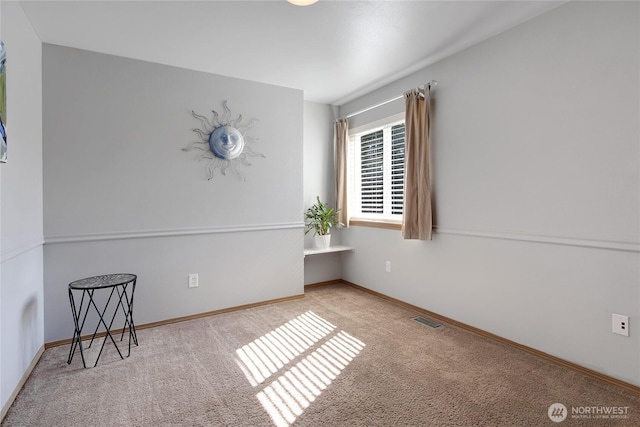 unfurnished room featuring carpet floors, baseboards, and visible vents