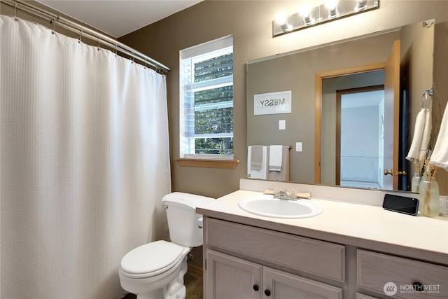 bathroom featuring vanity and toilet