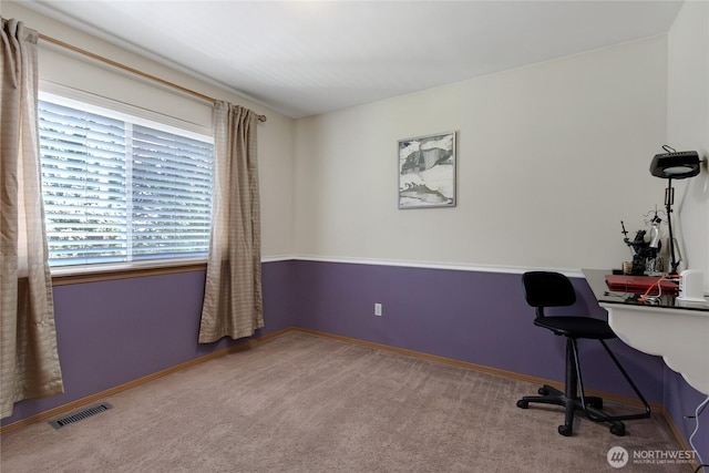 unfurnished office featuring baseboards, carpet, and visible vents