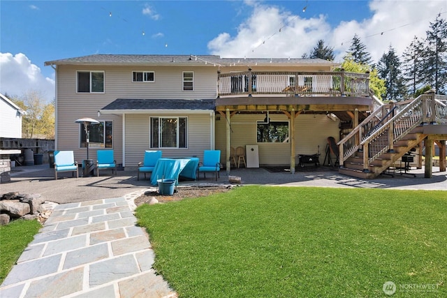 rear view of house with stairs, a patio area, a wooden deck, and a yard