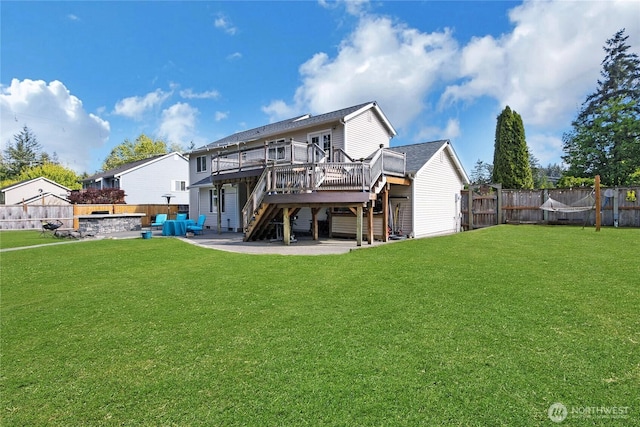 back of house featuring stairs, a wooden deck, a fenced backyard, a patio, and a yard