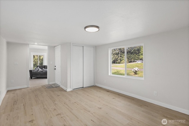8661 State Highway 303 NE, Bremerton, WA 98311 - unfurnished bedroom featuring baseboards, a closet, and light wood finished floors